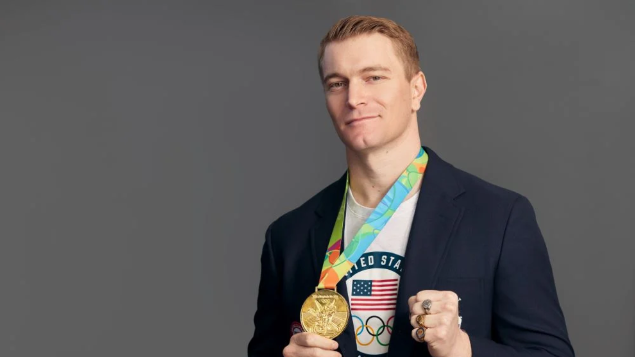 man holding up a medal